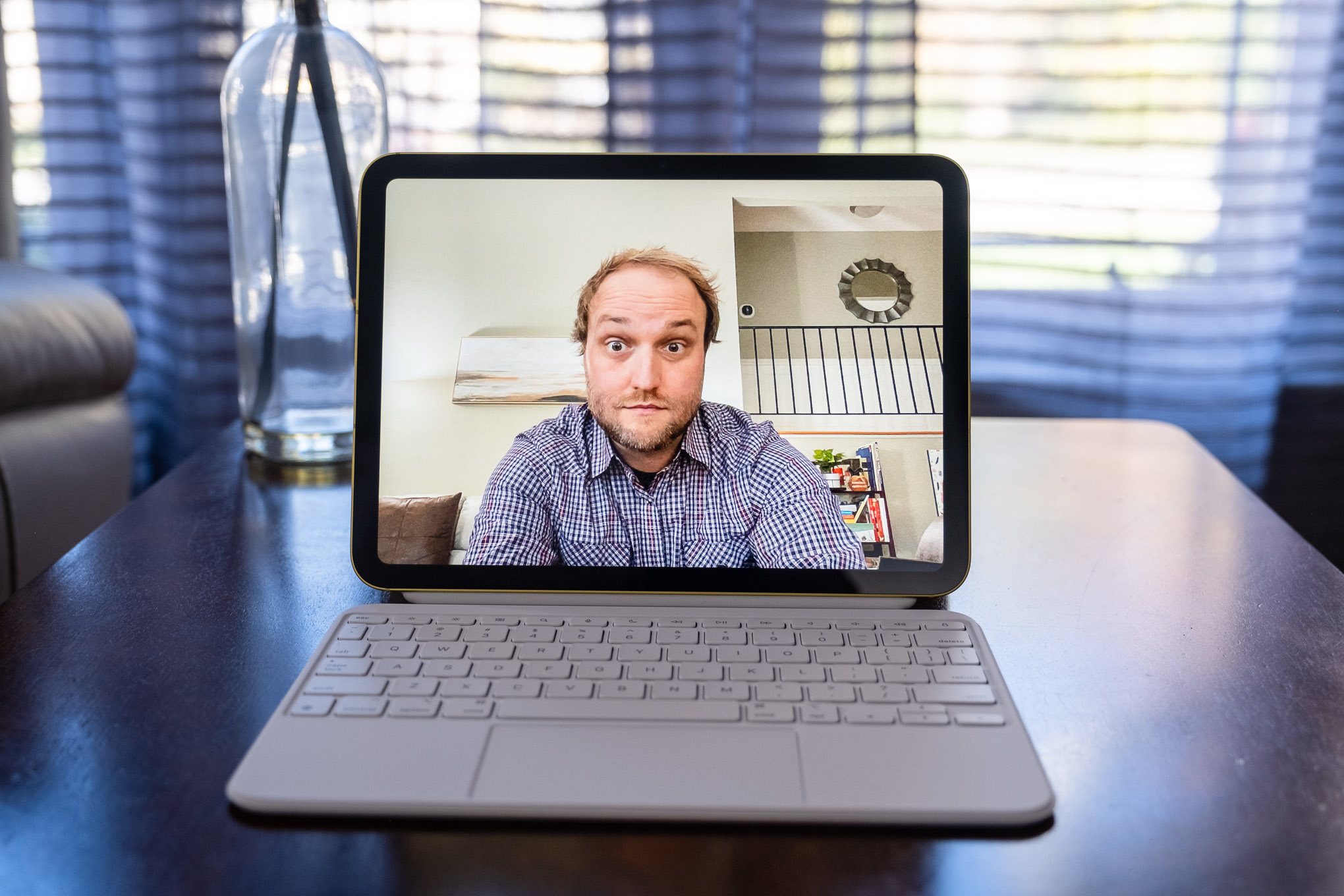 A 10th gen iPad in a Magic Keyboard Folio with the camera app open showing the view from the front-facing camera.