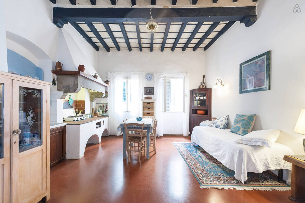 Studio apartment with blue ceiling wood beams and vintage furniture.