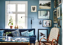Blue-themed living room with a gallery of pictures.