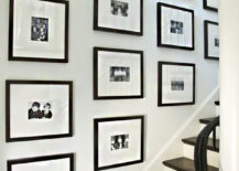 Stairway gallery with black and white pictures in black frames.