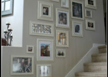 Family picture gallery in a stairway that has carpeted steps.