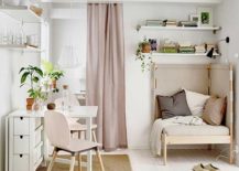 A cozy small room with white and pink colors featuring a comfortable corner chair, a table, and two chairs.