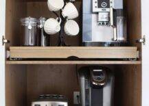 Coffee cabinet is fitted with pull out shelves.