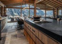 Gorgeous mountain view from the kitchen in a chalet with floor-to-ceiling windows.