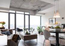 Modern Toronto condo with concrete ceiling, modern furniture, and floor-to-ceiling windows.