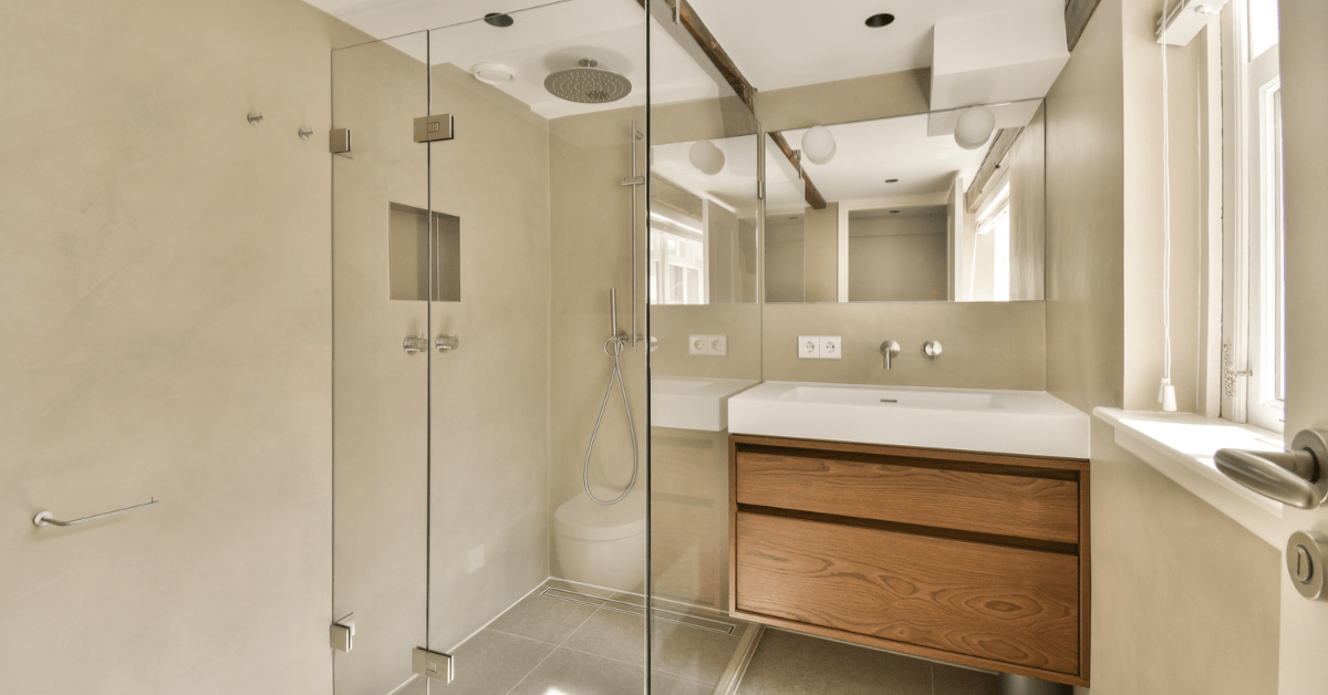 Small wet room bathroom with built-in storage shelf.