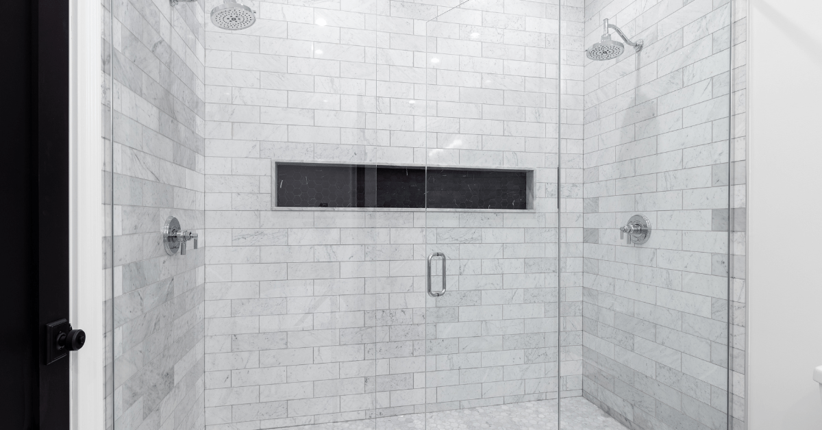 Marble subway tile shower with glass door.