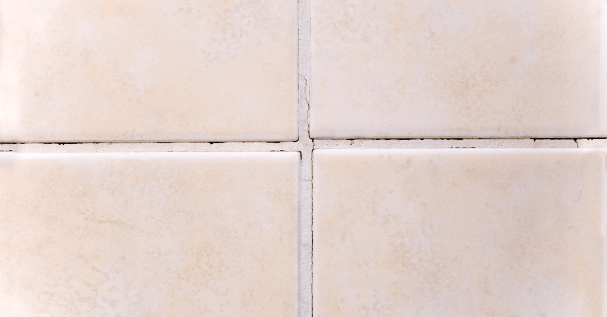 Closeup of tiles with cracked grout.