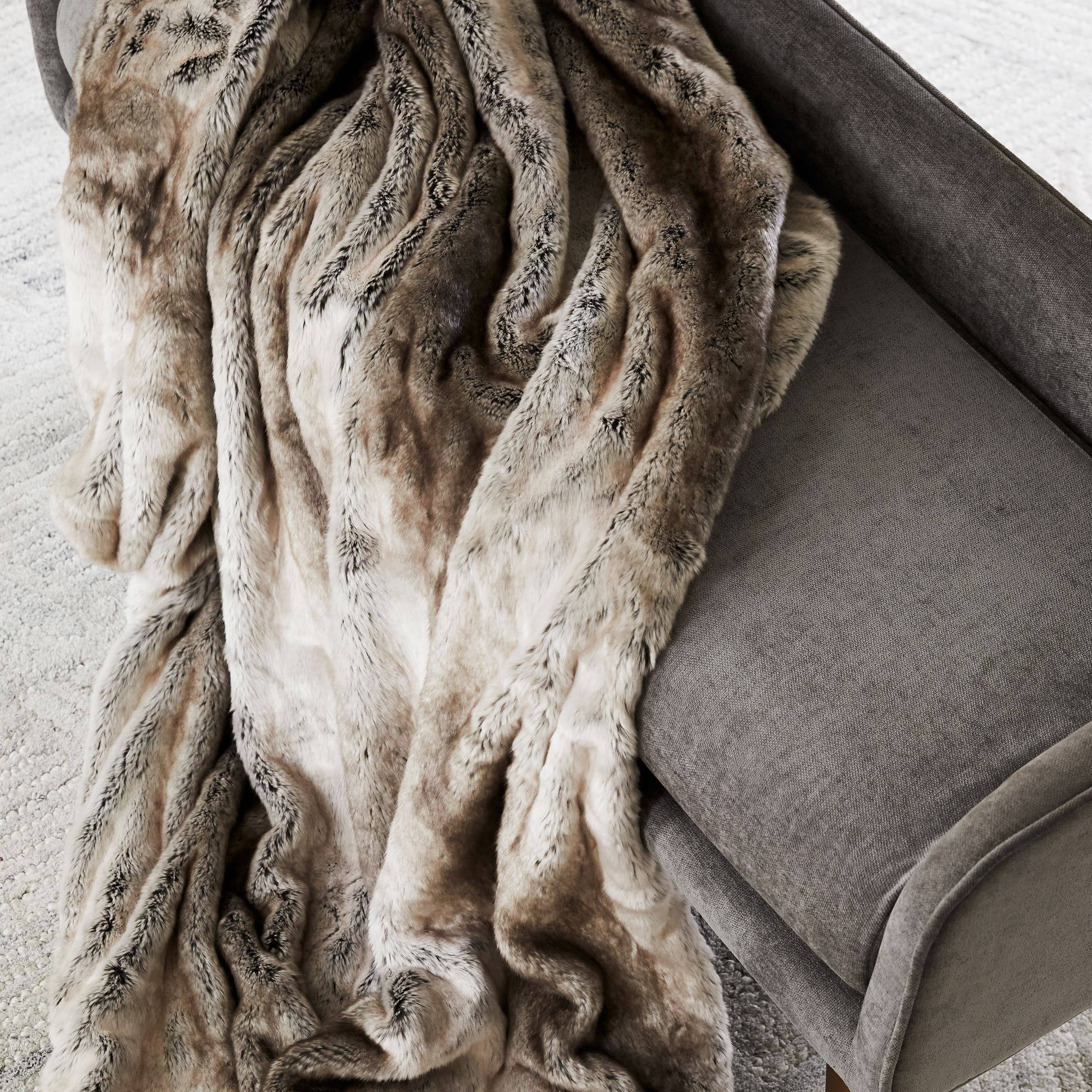 A fur throw on modern couch.