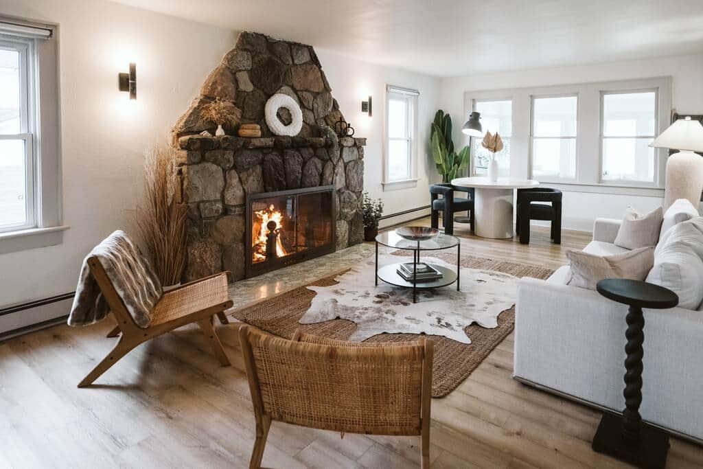 Modern beach house living room with stone fireplace.