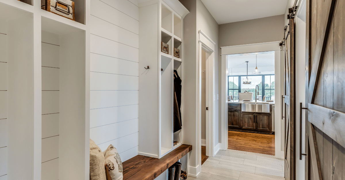 Walkway into a house with shiplap wall feature.