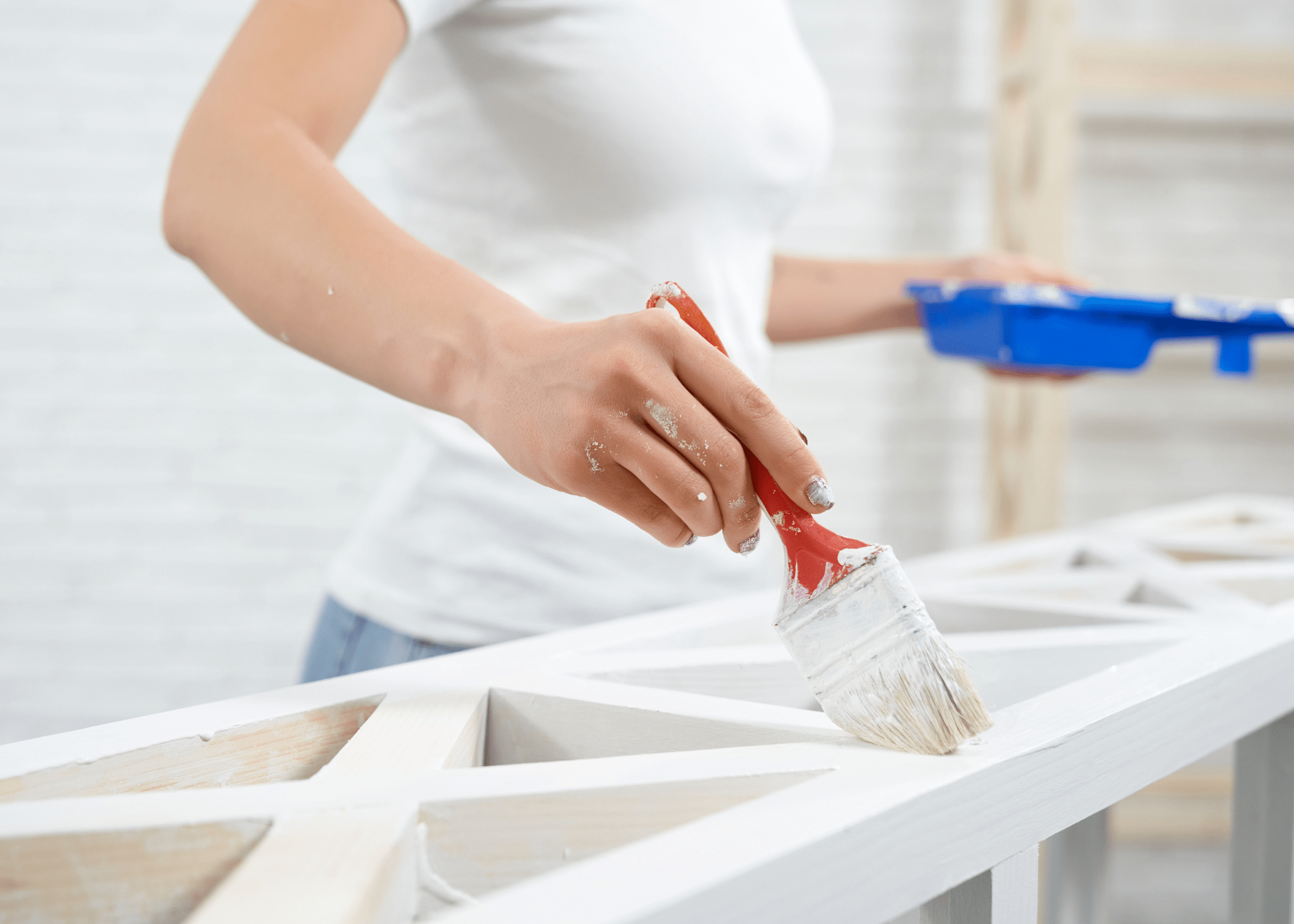 woman painting white piece of IKEA furniture