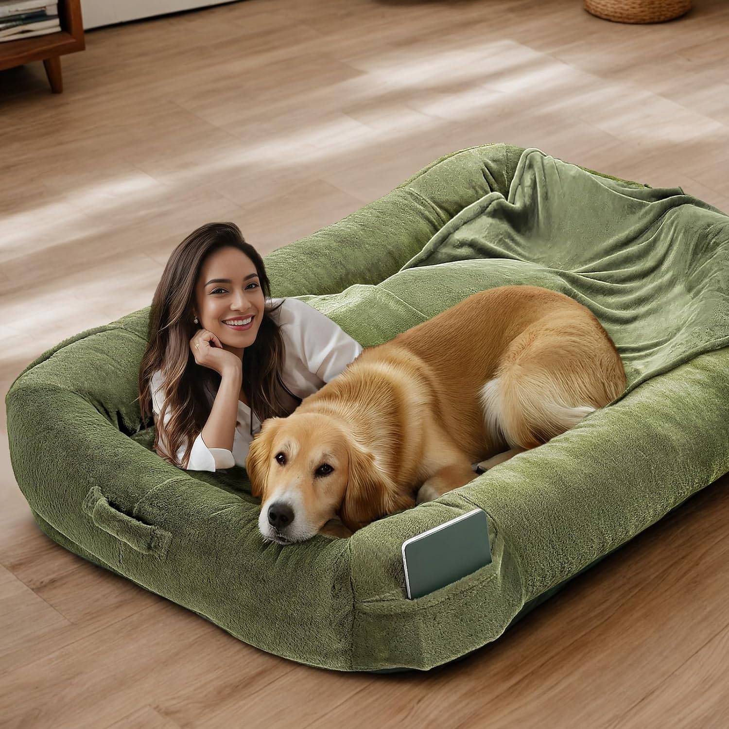 green human dog bed with woman and golden retriever sitting in it